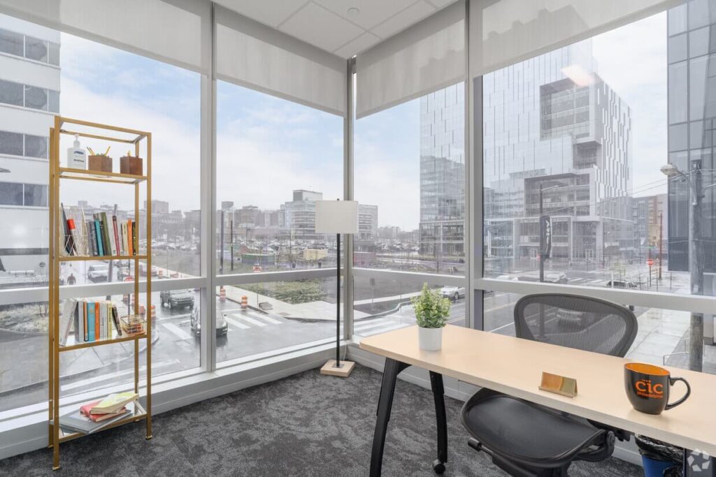 A CIC corner office with floor-to-ceiling windows and standard CIC furniture.