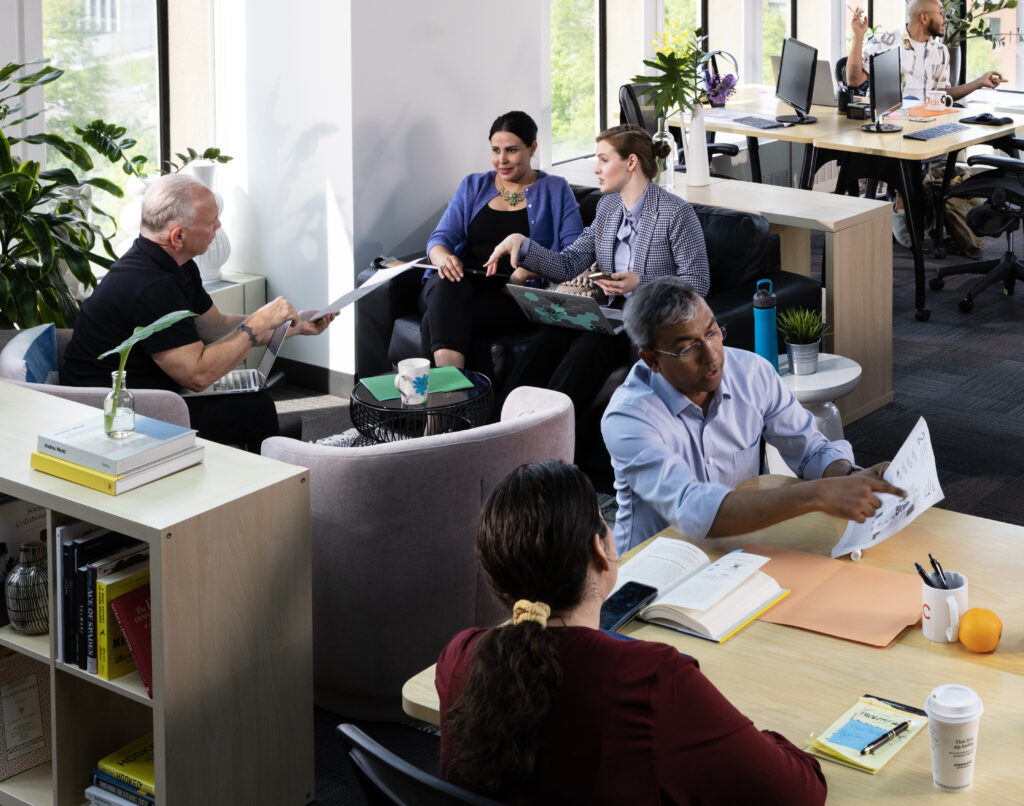 CIC flexible workspace with five staff members collaborating
