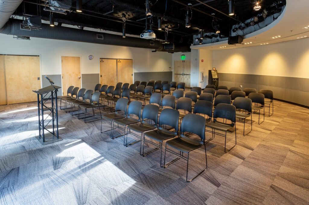 Havana hybrid event space with chairs in lecture style and podium at the front of the room