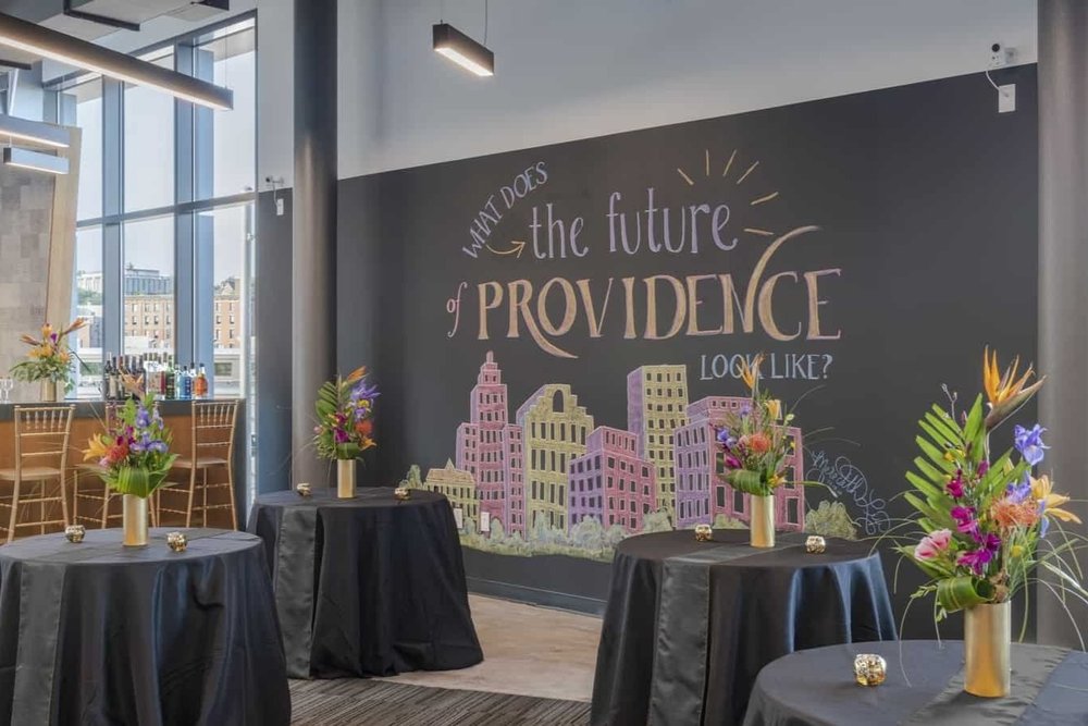 Cafe Lounge at CIC Providence with chalk wall and cabaret tables