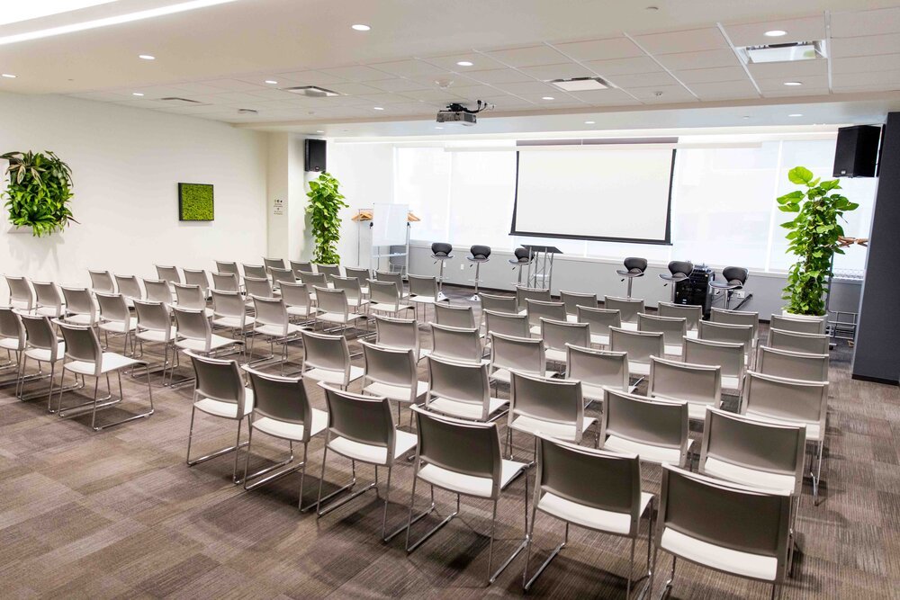 Delaware event space at CIC Philadelphia with chairs in lecture style and projector screen in front of the room down