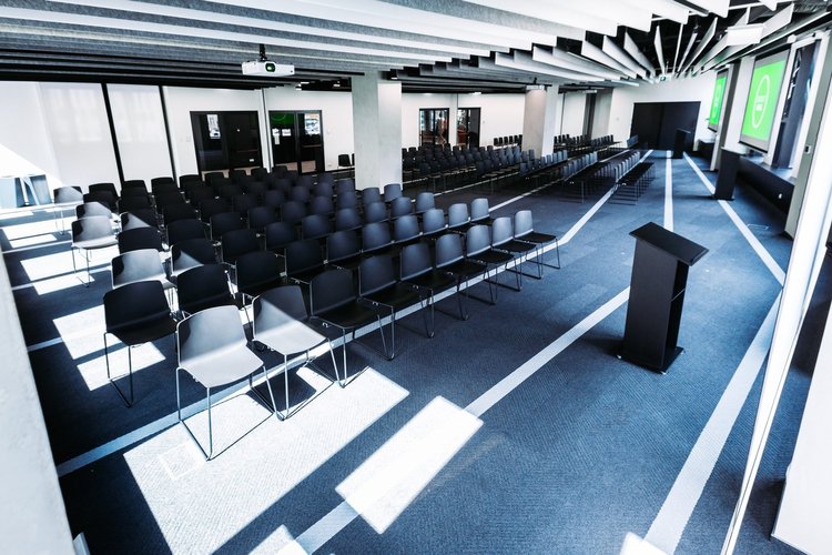 CIC Warsaw event space with chairs in lecture style and podium at the front of the room.