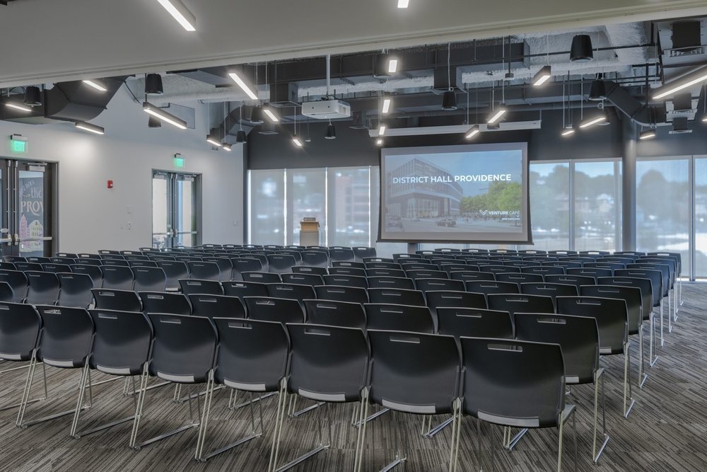 Matunuck event space with chairs in lecture style and project screen and podium at the front of the room