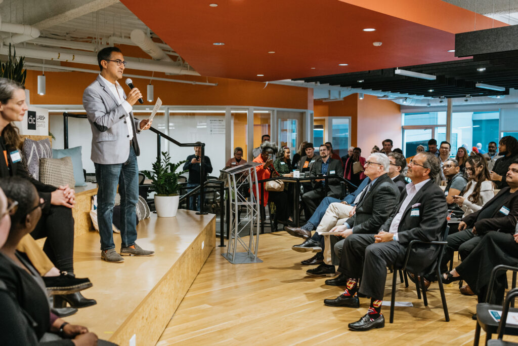 Man speaking to an audience in a CIC event space