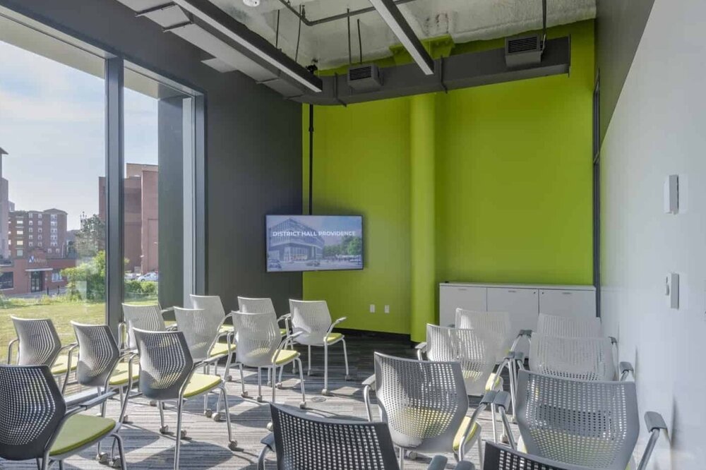 Sachuest conference room at CIC Providence with a floor-to-ceiling window, AV equipment, and chairs in lecture style