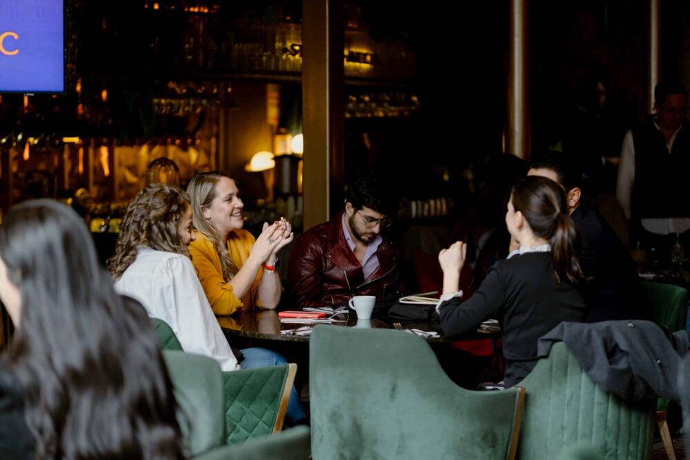 Group of people talking while sitting at a roundtable