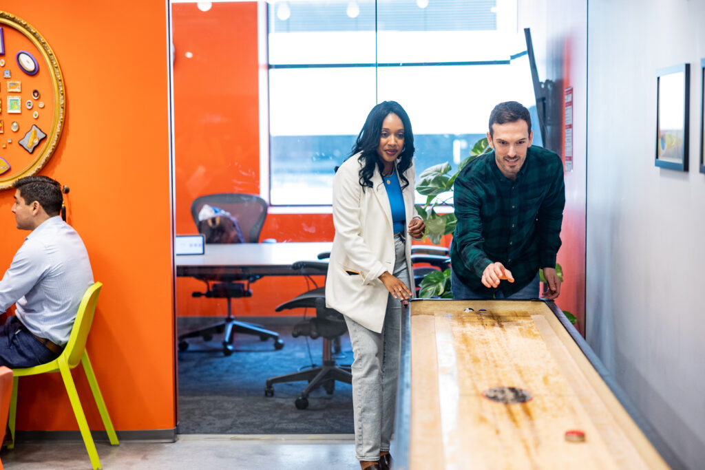 A man and a woman playing suffle board at CIC St. Louis