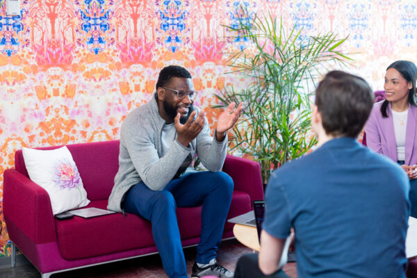 Two men and one woman talking in a nook at CIC St. Louis