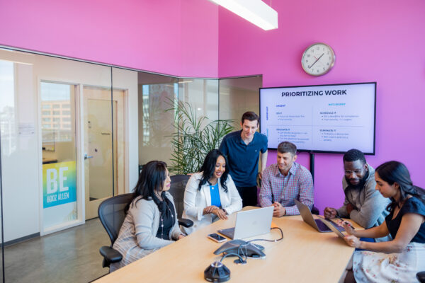 Several people having an engaging meeting in a conference room at CIC.