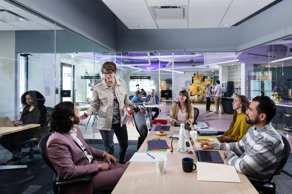 Five coworkers discuss business at a CIC conference room
