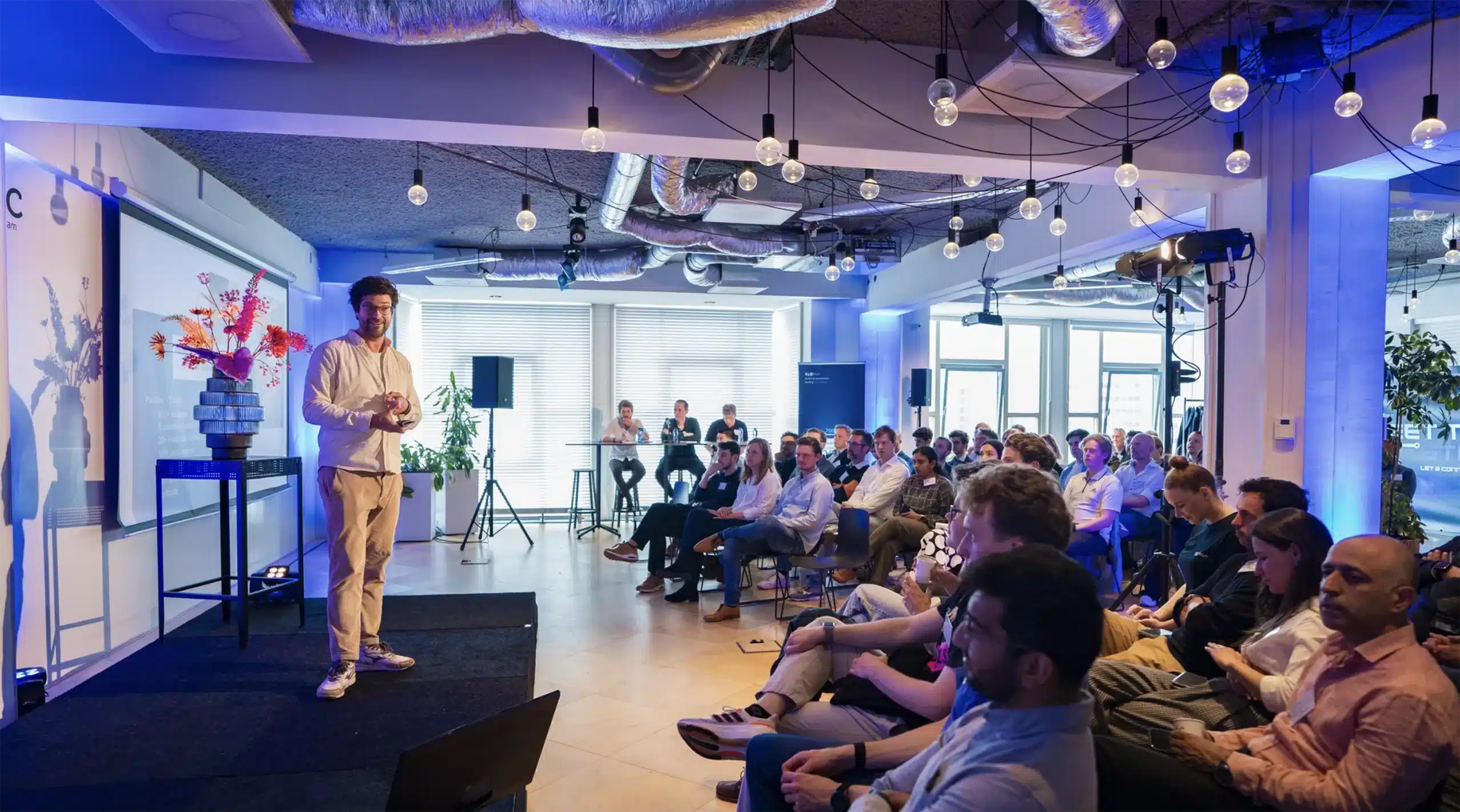 People watch a presenter on stage during an event at CIC Rotterdam