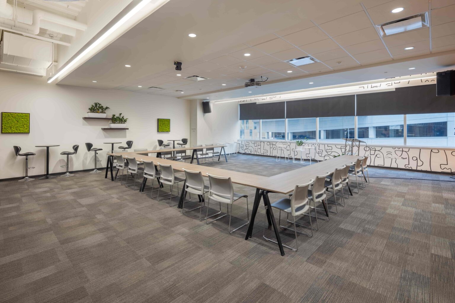 A CIC event space with tables, chairs, and an overhead projector
