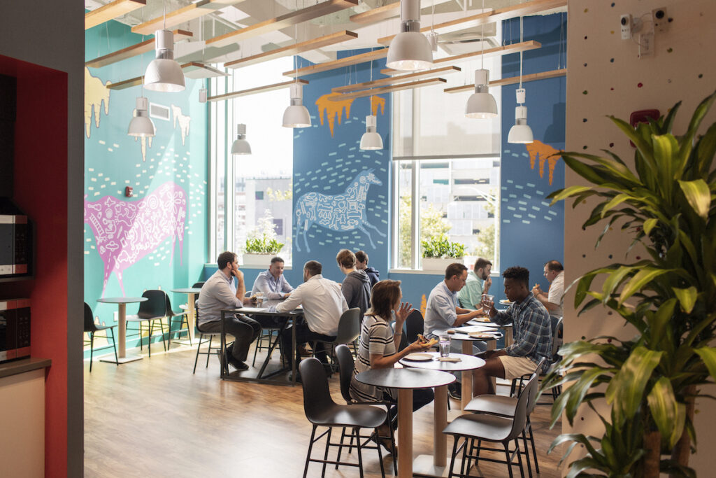 Clients chatting in a shared kitchen and CIC Providence