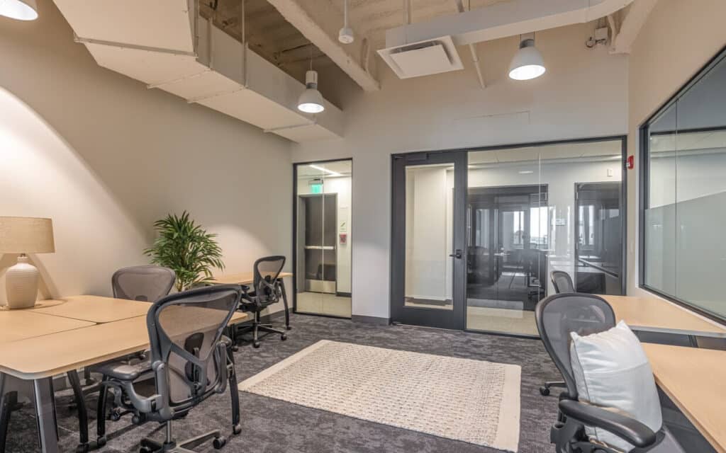 Private office space at CIC Providence. There are desks in different configurations, office chairs, and office space accessories.