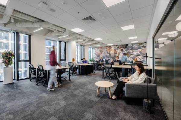 A private, flexible office space with pods, soft seating, and abundant natural light at CIC Warsaw.