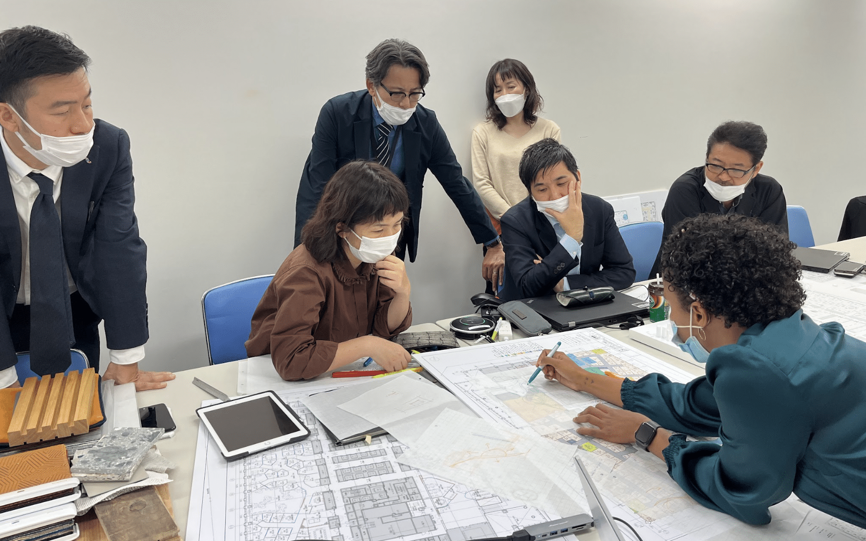 Stakeholders discuss design and construction plans in a meeting room
